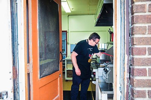 MIKAELA MACKENZIE / WINNIPEG FREE PRESS

Fraser Mason, owner of Sandy Lou's Diner, makes burgers in Winnipeg on Friday, May 1, 2020. The diner's only been open six months, but has already had its share of adversity, first getting into a dispute with their original landlord at a downtown hotel, forcing them to vacate that premises after only three months, then getting hit with COVID two weeks after opening at their second location, inside the LaSalle Hotel. For Dave Sanderson story.

Winnipeg Free Press 2020