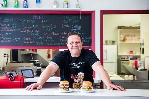 MIKAELA MACKENZIE / WINNIPEG FREE PRESS

Fraser Mason, owner of Sandy Lou's Diner, poses for a portrait with a double cheeseburger and a fatboy in Winnipeg on Friday, May 1, 2020. The diner's only been open six months, but has already had its share of adversity, first getting into a dispute with their original landlord at a downtown hotel, forcing them to vacate that premises after only three months, then getting hit with COVID two weeks after opening at their second location, inside the LaSalle Hotel. For Dave Sanderson story.

Winnipeg Free Press 2020