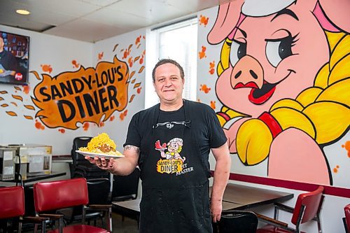 MIKAELA MACKENZIE / WINNIPEG FREE PRESS

Fraser Mason, owner of Sandy Lou's Diner, shows off a plate of Cincinnati-style chili in Winnipeg on Friday, May 1, 2020. The diner's only been open six months, but has already had its share of adversity, first getting into a dispute with their original landlord at a downtown hotel, forcing them to vacate that premises after only three months, then getting hit with COVID two weeks after opening at their second location, inside the LaSalle Hotel. For Dave Sanderson story.

Winnipeg Free Press 2020