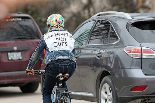 SHANNON VANRAES / WINNIPEG FREE PRESS
Cate Freisen wears a jacket reading "Communities Not Cuts" during a socially distant rally at the Manitoba Legislature on May 1, 2020. A few hundred people in vehicles and on bikes circled the legislative building, holding signs, honking horns and ringing bells over the noon-hour to protest job cuts at universities, crown corporations and elsewhere in the civil service.