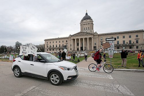 SHANNON VANRAES / WINNIPEG FREE PRESS
Communities Not Cuts organized a "honk-a-thon" at the Manitoba Legislature on May 1, 2020, to protest job cuts at universities, crown corporations and elsewhere in the civil service. A few hundred people in vehicles and on bikes circled the legislative building, holding signs, honking horns and ringing bells over the noon-hour.
