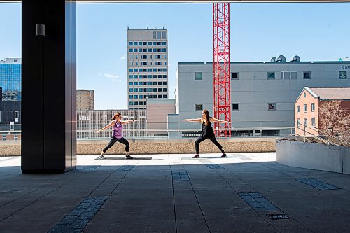 Mike Sudoma / Winnipeg Free Press
(Left to Right) Kelly Komar and Jess Monette, enjoy the weather as they practice some yoga outside of their workplace in True North Square Wednesday afternoon as the buildings gym facility is closed down due to CoVid 19.
May 6, 2020