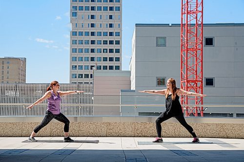 Mike Sudoma / Winnipeg Free Press
(Left to Right) Kelly Komar and Jess Monette, enjoy the weather as they practice some yoga outside of their workplace in True North Square Wednesday afternoon as the buildings gym facility is closed down due to CoVid 19.
May 6, 2020