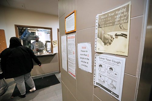 JOHN WOODS / WINNIPEG FREE PRESS
Salavation Army staff member Charles talks to a client as signage shows COVID-19 recommendations at the Salvation Army in Winnipeg Wednesday, May 6, 2020. 

Reporter: Thorpe/Part of 24 hr life during COVID-19 project