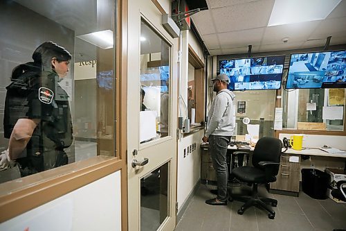 JOHN WOODS / WINNIPEG FREE PRESS
Salavation Army staff member Charles, right, talks to a client at the Salvation Army as contracted security officer Oliver Muswagon looks on in Winnipeg Wednesday, May 6, 2020. 

Reporter: Thorpe/Part of 24 hr life during COVID-19 project