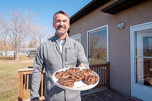 Mike Sudoma / Winnipeg Free Press
Tony Shea proudly displaying his freshly grilled burgers at his home Wednesday evening
May 6, 2020