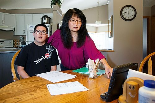 MIKE DEAL / WINNIPEG FREE PRESS
Cathy Cowen and her son Daniel, 20, during a lesson with an EA via video conference from their kitchen table.
Pembina Trails parents are worried about the impact widespread EA layoffs, which begin on Monday, will have on students with disabilities. Children in the Life Skills program have built relationships with EAs, who work on both literacy and numeracy, as well as behaviour lessons with them. They have tight bonds with their EAs, sometimes more-so than teachers. Without in-person physio or speech pathologist support, students are already struggling to adapt during distance learning.
See Maggie Macintosh story
200508 - Friday, May 08, 2020.