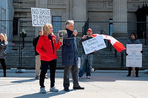 Daniel Crump / Winnipeg Free Press. Event organizer Gerry Bohemier (middle), speaks to a group of around a hundred people attending an anti-lockdown rally at the Manitoba Legislature. The event was hosted by a group called Winnipeg Aware People with a Passion for the Truth. May 9, 2020.