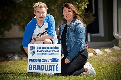 JOHN WOODS / WINNIPEG FREE PRESS
Oliver Spencer and his mother Sherri Brayshaw-Spencer are photographed with an Oak Park High School grad lawn sign outside their home in Winnipeg Sunday, May 10, 2020. The signs were put on the lawns of students who are graduating amid the COVID-19 chaos.

Reporter: Allen