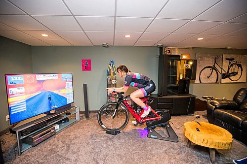 MIKAELA MACKENZIE / WINNIPEG FREE PRESS

Stephanie Roberecki uses her stationary bike and an app called Zwift to keep in shape while staying at home in Winnipeg on Wednesday, May 13, 2020. For Sabrina Carnevale story.

Winnipeg Free Press 2020