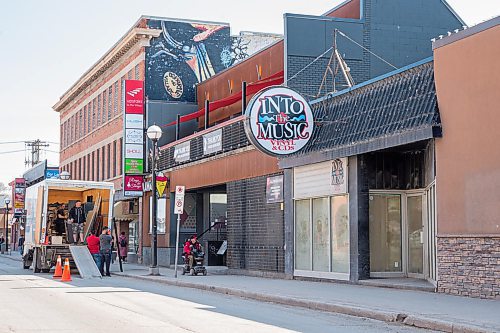 Mike Sudoma / Winnipeg Free Press
Owner Brian Koshul and others pack up Upstairs in the Village as Into the Musics store front sits vacant beside them Friday afternoon
May 15, 2020