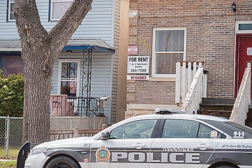 Mike Sudoma / Winnipeg Free Press
A neighbour looks out of her window as police investigate further into a homicide at a Redwood Ave apartment block which took place late Friday morning
May 16, 2020