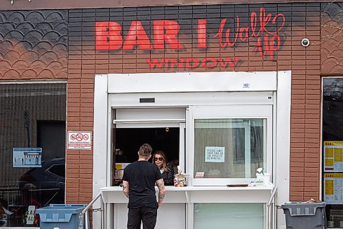Mike Sudoma / Winnipeg Free Press
A worker at Bar Italia serves a customer from their newly installed pickup window Saturday afternoon
May 16, 2020