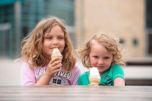 Mike Sudoma / Winnipeg Free Press
Sisters Avery (left) and Autumn Carroll (right) enjoy an ice cream cone on the Forks patio Saturday afternoon
May 16, 2020