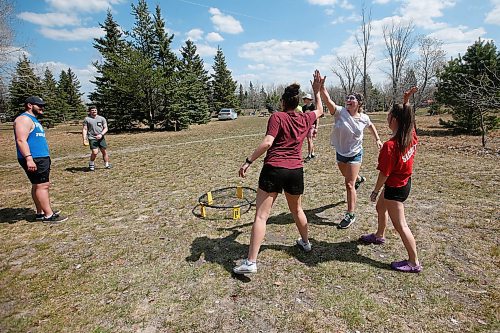 JOHN WOODS / WINNIPEG FREE PRESS
Sara Scholefield, left front, Jessica Popowich, centre front, and Kelsey Weibe, right front, high five each other as they celebrate after defeating their male friends Jonathan Bennett, Zach Wood and Domenic Horvath in a game of Spike Ball as they were out enjoying some camping in Birds Hill Park just north of Winnipeg Sunday, May 17, 2020. 

Reporter: Waldman