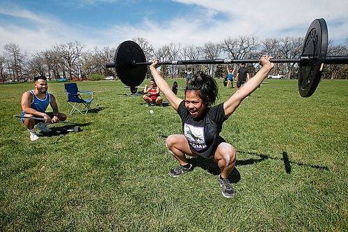 JOHN WOODS / WINNIPEG FREE PRESS
Justin Liwanag, coach at NXT LVL Performance, left, encourages Janine Vergara as she does the squat snatch with other athletes, from front to back, Jamie Garcia-Vendivil, Jeffrey Castillo, Christina Garcia-Vendivil, Stephanie Hamm in Kildonan Park Monday, May 18, 2020. Liwanag decided to get creative with his training during the COVID-19 closures and took his class outside of the gym taking advantage of the weather and physical distance.

Reporter: Standup