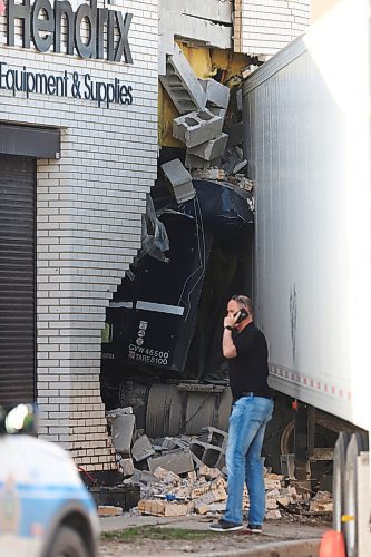MIKE DEAL / WINNIPEG FREE PRESS
The cab of a semi-truck came to rest inside the Russell Hendrix restaurant supply store at Erin Street and Ellis Avenue after being in a collision with a car early Wednesday morning. 
200520 - Wednesday, May 20, 2020