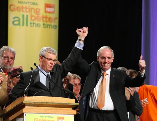 Brandon Sun Leadership candidate Steve Ashton, right, gives the thumbs-up for Premier-designate Greg Selinger during the Manitoba NDP leadership convention at the Winnipeg Convention Centre on Saturday afternoon. (Bruce Bumstead/Brandon Sun)
