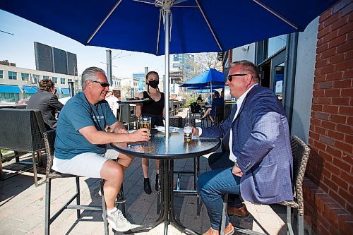 MIKE DEAL / WINNIPEG FREE PRESS
Paul Kuzina (left) and Michael Falk (right) with server Beth Popoff on the patio at the Earls on Main Street Wednesday afternoon.
See Bens story on top 5 patios
200520 - Wednesday, May 20, 2020.