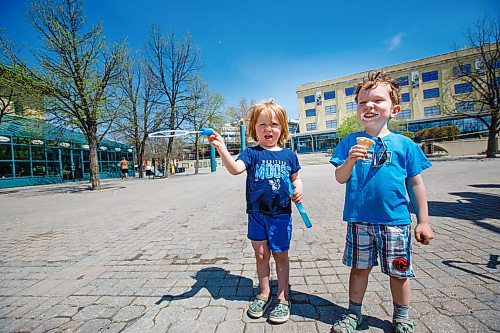 MIKE DEAL / WINNIPEG FREE PRESS
Jack Coote, 3, eats his ice cream cone while his cousin Freddie Gibson Scott, 4, waves his bubble wand about during a visit to The Forks Wednesday afternoon.
200520 - Wednesday, May 20, 2020.