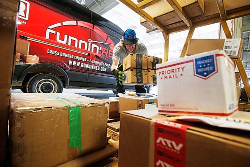 JOHN WOODS / WINNIPEG FREE PRESS
Mike Caners of Runnin Red, a cross border courier, unloads packages from Emerson in their warehouse in Winnipeg Wednesday, May 20, 2020. Runnin Red co-owner Trevor Froese says that currently they are probably doing four to five times the normal volume.

Reporter: Waldman