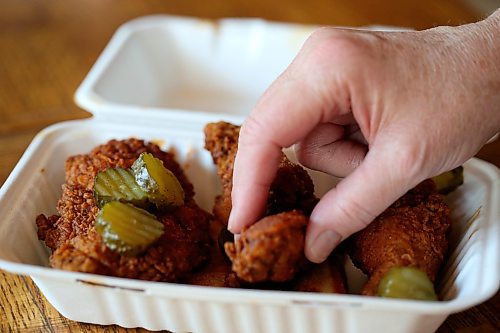 SHANNON VANRAES / WINNIPEG FREE PRESS
A half bird worth of fried chicken, served with bread and butter pickles, from Mercy Me Nashville Chicken arrives at a Winnipeg home in a delivery container on May 20, 2020.