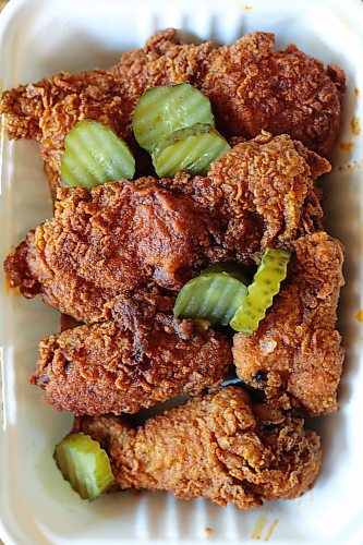SHANNON VANRAES / WINNIPEG FREE PRESS
A half bird worth of fried chicken, served with bread and butter pickles, from Mercy Me Nashville Chicken arrives at a Winnipeg home in a delivery container on May 20, 2020.