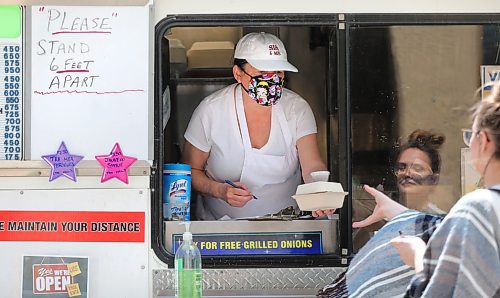 RUTH BONNEVILLE / WINNIPEG FREE PRESS

Local - Food Trucks

Joyce Powers, owner of Sis & Me Food truck, serves customers from her pick-up window inside her truck which is parked on Broadway and Edmonton on Friday. 

May 22, 2020