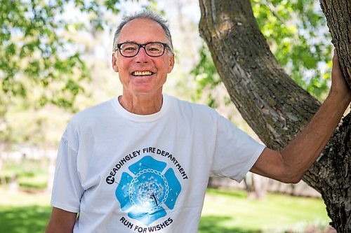 MIKAELA MACKENZIE / WINNIPEG FREE PRESS

Glenn Reimer, deputy chief for EMS, Headingley Fire Department and race organizer for Run for Wishes, poses for a portrait in his front yard in Headingley on Wednesday, May 27, 2020. For Brenda Suderman Sunday Special story.
Winnipeg Free Press 2020.
