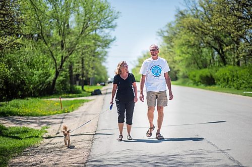 MIKAELA MACKENZIE / WINNIPEG FREE PRESS

Glenn Reimer, deputy chief for EMS, Headingley Fire Department and race organizer for Run for Wishes, goes for a walk with his wife, Joanne Reimer, and dog, Echo, in Headingley on Wednesday, May 27, 2020. For Brenda Suderman Sunday Special story.
Winnipeg Free Press 2020.
