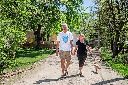 MIKAELA MACKENZIE / WINNIPEG FREE PRESS

Glenn Reimer, deputy chief for EMS, Headingley Fire Department and race organizer for Run for Wishes, goes for a walk with his wife, Joanne Reimer, and dog, Echo, in Headingley on Wednesday, May 27, 2020. For Brenda Suderman Sunday Special story.
Winnipeg Free Press 2020.