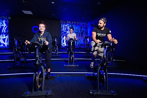 Mike Sudoma / Winnipeg Free Press
Ignite Cycle and Strength owners, Serena Nelko (left), Denis Camracosky (right) and trainer, Crystal Teichrieb (center) pedal exercise bikes in the cycle room in their workout fascility Wednesday afternoon
May 27, 2020