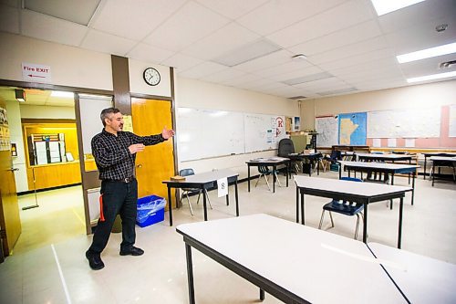 MIKAELA MACKENZIE / WINNIPEG FREE PRESS

Dominic Zagari, vice principal, shows how desks are set out to conform with social distancing measures and tape marks the flow of travel for students ahead of the partial opening at Kelvin High School in Winnipeg on Friday, May 29, 2020. Standup.
Winnipeg Free Press 2020.