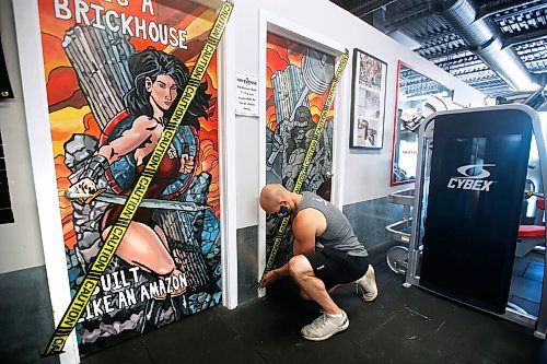 JOHN WOODS / WINNIPEG FREE PRESS
Paul Taylor, owner of Brickhouse Gym, tapes off locker rooms as he prepares his gym for re-opening Sunday, May 31, 2020. He will be reducing capacity, cleaning equipment, staff will be masked, and many other things to follow Manitoba COVID-19 phase 2 requirements.

Reporter: Rollason