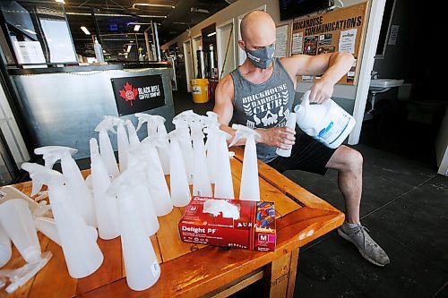 JOHN WOODS / WINNIPEG FREE PRESS
Paul Taylor, owner of Brickhouse Gym, fills customer sanitizer bottles as he prepares his gym for re-opening Sunday, May 31, 2020. He will be reducing capacity, cleaning equipment, staff will be masked, and many other things to follow Manitoba COVID-19 phase 2 requirements.

Reporter: Rollason