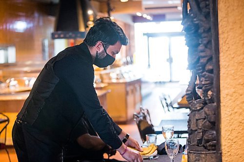 MIKAELA MACKENZIE / WINNIPEG FREE PRESS

Shaan, server, wears a mask at the East India Company on re-opening day in Winnipeg on Monday, June 1, 2020. For Malak Abas story.
Winnipeg Free Press 2020.