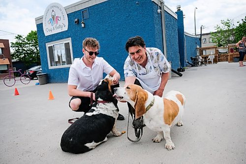 Daniel Crump / Winnipeg Free Press. Restaurant owner Fern Kirouac (right) and his son Zac Kirouac (left) with their Bassett Hounds Dug (light) and Betty (dark), for whom the restaurant is named. June 2, 2020.