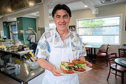 Daniel Crump / Winnipeg Free Press. Fern Kirouac, owner od Dug + Bettys restaurant, holds a club sandwich. The sandwich, which is made with a special tomato balsamic vinager jelly, is a popular menu item. June 2, 2020.