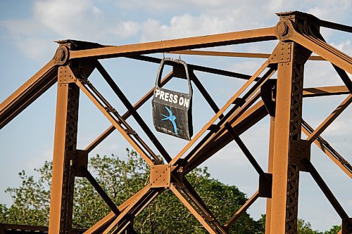 Mike Sudoma / Winnipeg Free Press
A car door painted with the words Press On sits atop the St James train bridge Tuesday afternoon
June 2, 2020