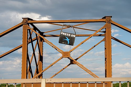 Mike Sudoma / Winnipeg Free Press
A car door painted with the words Press On sits atop the St James train bridge Tuesday afternoon
June 2, 2020