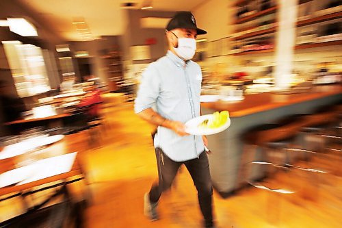 JOHN WOODS / WINNIPEG FREE PRESS
Dylan Wallace, restaurant manager, takes a dish to a guest at Maque on Dorchester in Winnipeg Wednesday, June 3, 2020. 

Reporter: Gillmor