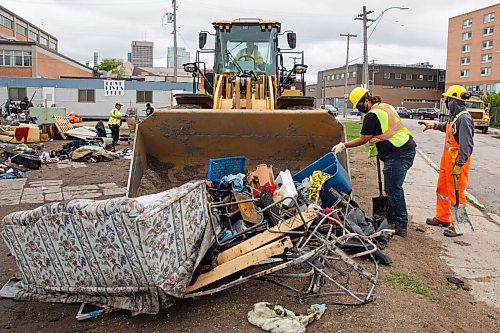 MIKE DEAL / WINNIPEG FREE PRESS
Cleanup of the Point Douglas homeless encampments begins Wednesday morning. People sort through mounds of belongings prior to city crews arrival with a frontend loader and a large truck to remove left over garbage. 
Rick Lees with the Main Street Project and Mark Reshaur Asst. Chief of the Winnipeg Fire Paramedic Service were on hand to distribute pamphlets detailing the order to vacate by Friday.
200610 - Wednesday, June 10, 2020.