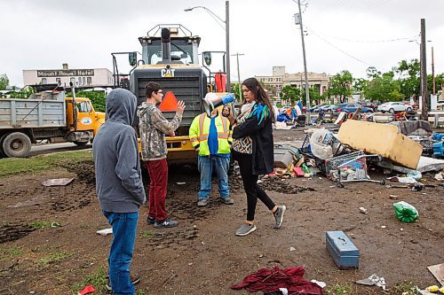 MIKE DEAL / WINNIPEG FREE PRESS
A city crew is stopped by protesters from removing debris at the Point Douglas homeless encampments Wednesday morning. 
Rick Lees with the Main Street Project and Mark Reshaur Asst. Chief of the Winnipeg Fire Paramedic Service were on hand to distribute pamphlets detailing the order to vacate by Friday.
200610 - Wednesday, June 10, 2020.