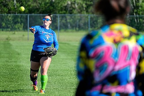 Daniel Crump / Winnipeg Free Press. Stacey Lazor (left) tosses a ball to her teammate, Tasha Bouchard, during pregame warmup at Buhler Recreational Park. June 10, 2020.
