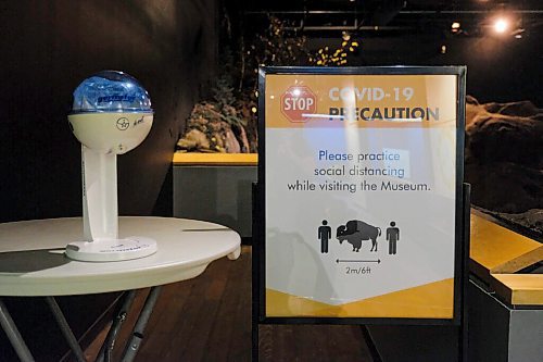Daniel Crump / Winnipeg Free Press. Hand sanitizer stations, and signs reminding people to keep two meter (or one bison length) apart, can be found all over the Manitoba Museum. June 13, 2020.