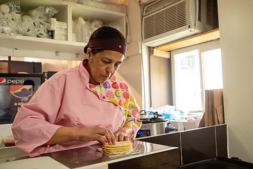 Mike Sudoma / Winnipeg Free Press
BMC Market owner, Betty Calteron, packages soft tortilla shells to go along with their Family pack take out dish Saturday afternoon
June 14, 2020