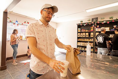 Mike Sudoma / Winnipeg Free Press
Nic Sinclair picks up his BMC Market take out order Saturday afternoon
June 14, 2020