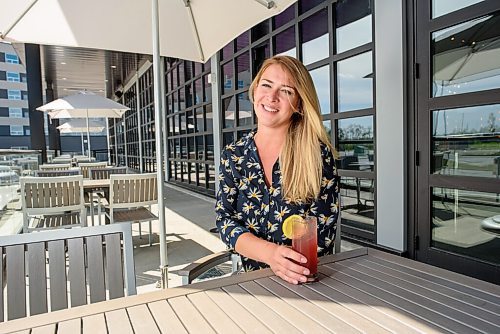 JESSE BOILY  / WINNIPEG FREE PRESS
Agnes Krahn, the manager of the Rec Room in Winnipeg, sits on the patio and shows one of the drinks offered at the Rec Room on Monday. Rec Room is slowly phasing their opening with the patio first. Monday, June 15, 2020.
Reporter: Randall King