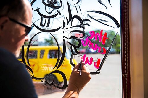 MIKAELA MACKENZIE / WINNIPEG FREE PRESS

Todd Van Hussen paints Canada Day window art at The Crusty Bun in Winnipeg on Wednesday, June 17, 2020. For Ben Waldman story.
Winnipeg Free Press 2020.