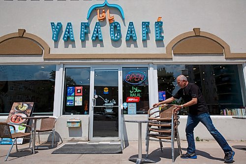 MIKE DEAL / WINNIPEG FREE PRESS
Rafe Abulla, owner of the Yafa Cafe on Portage Avenue sets out some patio tables and chairs. Rafe was in the process of building a patio seating area behind the restaurant when most of the stuff he had set out was stolen by a guy with a truck overnight. The only table that wasnt stolen was probably too heavy to pick up as it is all one piece; a table and four seats.
See Gabrielle's story
200617 - Wednesday, June 17, 2020.